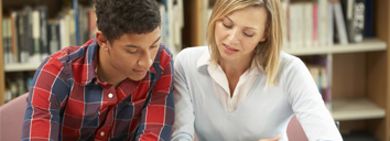 Teacher helping a student study English